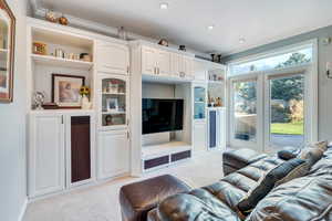 Living room with light colored carpet and crown molding