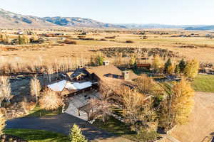 Birds eye view of property with a mountain view and a rural view