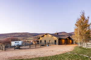 View of horse barn with a mountain view