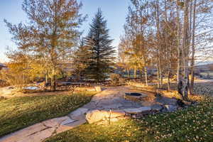 View of yard featuring an outdoor fire pit and a patio area