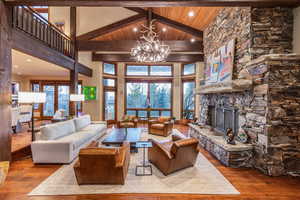 Living room featuring light hardwood / wood-style floors, high vaulted ceiling, and a wealth of natural light