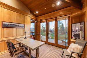 Office area with vaulted ceiling, wood ceiling, and wooden walls