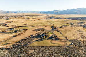 Birds eye view of property with a mountain view and a rural view