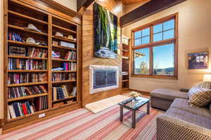 Living room with lofted ceiling and wood walls