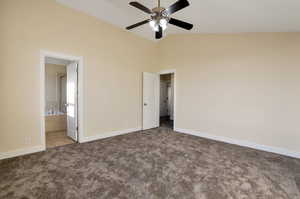 Unfurnished bedroom with ceiling fan, light carpet, high vaulted ceiling, and ensuite bath