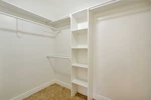 Spacious closet with light tile patterned floors