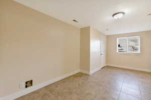 Unfurnished room with light tile patterned floors