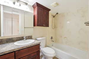 Full bathroom with shower / tub combination, vanity, and toilet