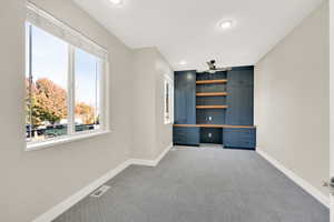 Home office with custom built in cabinets.