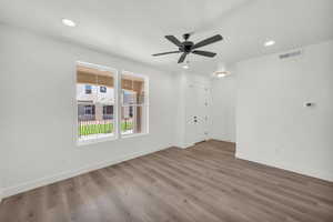 Spare room with ceiling fan, hardwood / wood-style floors, and a textured ceiling