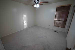 Spare room with carpet flooring and ceiling fan