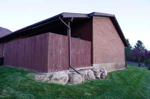 View of side of property with a yard