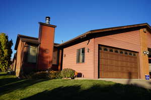 View of front facade with a front yard and a garage