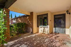 Doorway to property with a patio area