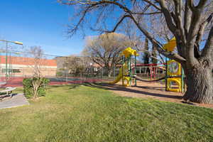 View of yard with a playground and tennis court