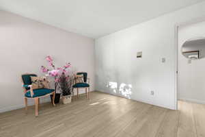 Sitting room with light hardwood / wood-style flooring