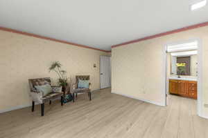 Sitting room with sink and light hardwood / wood-style floors