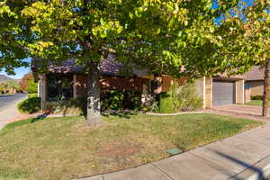 View of front of house with a mountain view, a garage, and a front yard