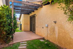 Exterior space with a pergola and cooling unit