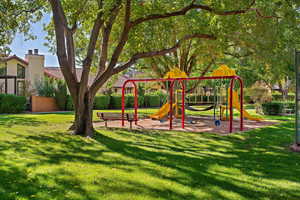 View of playground featuring a yard