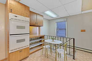 Kitchen with a drop ceiling and double oven