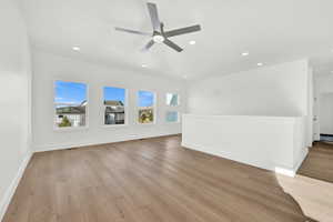 Unfurnished living room with ceiling fan and light hardwood / wood-style floors