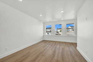 Empty room with light hardwood / wood-style floors