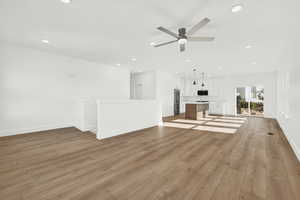 Unfurnished living room featuring ceiling fan and light wood-type flooring