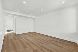 Empty room with light hardwood / wood-style flooring