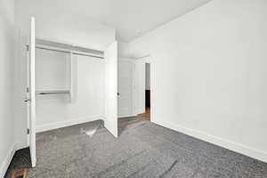 Unfurnished bedroom with carpet floors and a closet