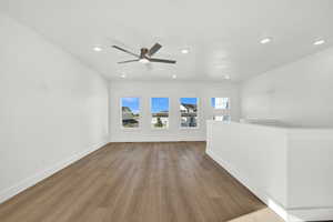 Interior space featuring ceiling fan and light wood-type flooring