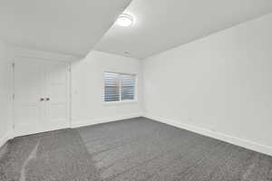 Unfurnished bedroom featuring carpet and a closet