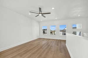 Spare room with ceiling fan and light hardwood / wood-style floors