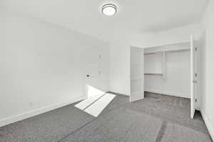 Unfurnished bedroom featuring a closet and carpet floors