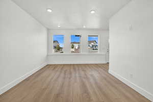 Empty room with light hardwood / wood-style flooring