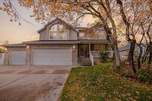 View of front of home featuring a porch and a garage