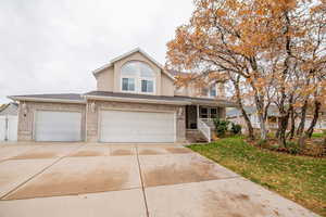 View of front property with a front lawn and a garage