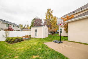 View of yard featuring a shed and a patio area