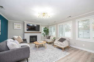 Spacious Living Room with Cozy Fireplace & Lots of Windows For Natural Light