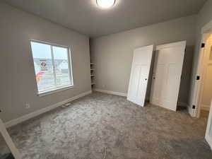 Unfurnished bedroom featuring a textured ceiling and carpet floors