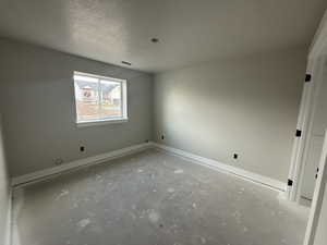 Empty room with a textured ceiling