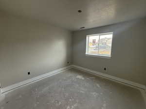 Empty room featuring a textured ceiling