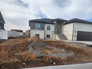 View of front facade featuring a garage