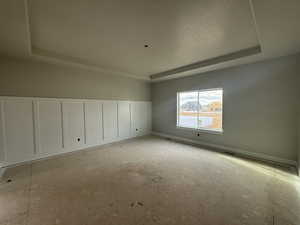 Unfurnished room with a tray ceiling