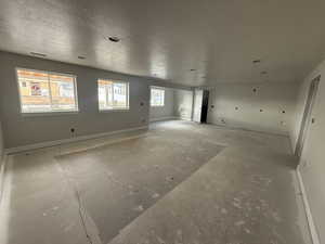 Spare room featuring a textured ceiling and a wealth of natural light