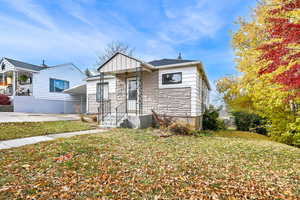 Bungalow-style house with a front yard and a carport