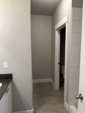 Bathroom featuring tile patterned flooring, vanity, and toilet