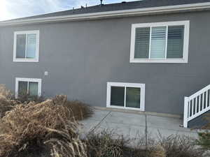 View of side of home featuring a patio area