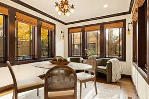 Sunroom / solarium with an inviting chandelier