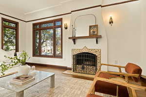 Sitting room with a fireplace, wood-type flooring, and plenty of natural light